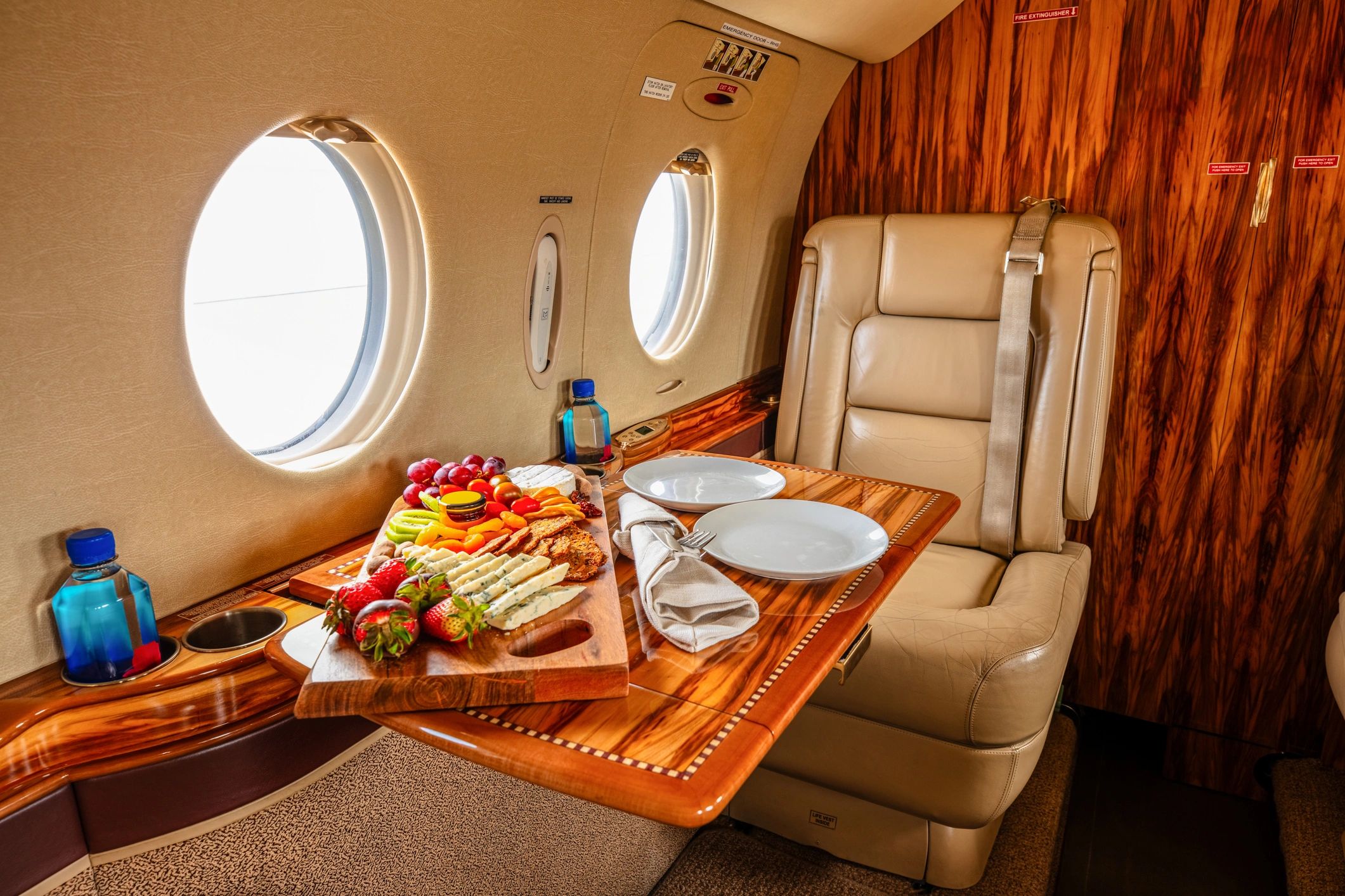 Private jet style cabin interior with leather seats and champagne