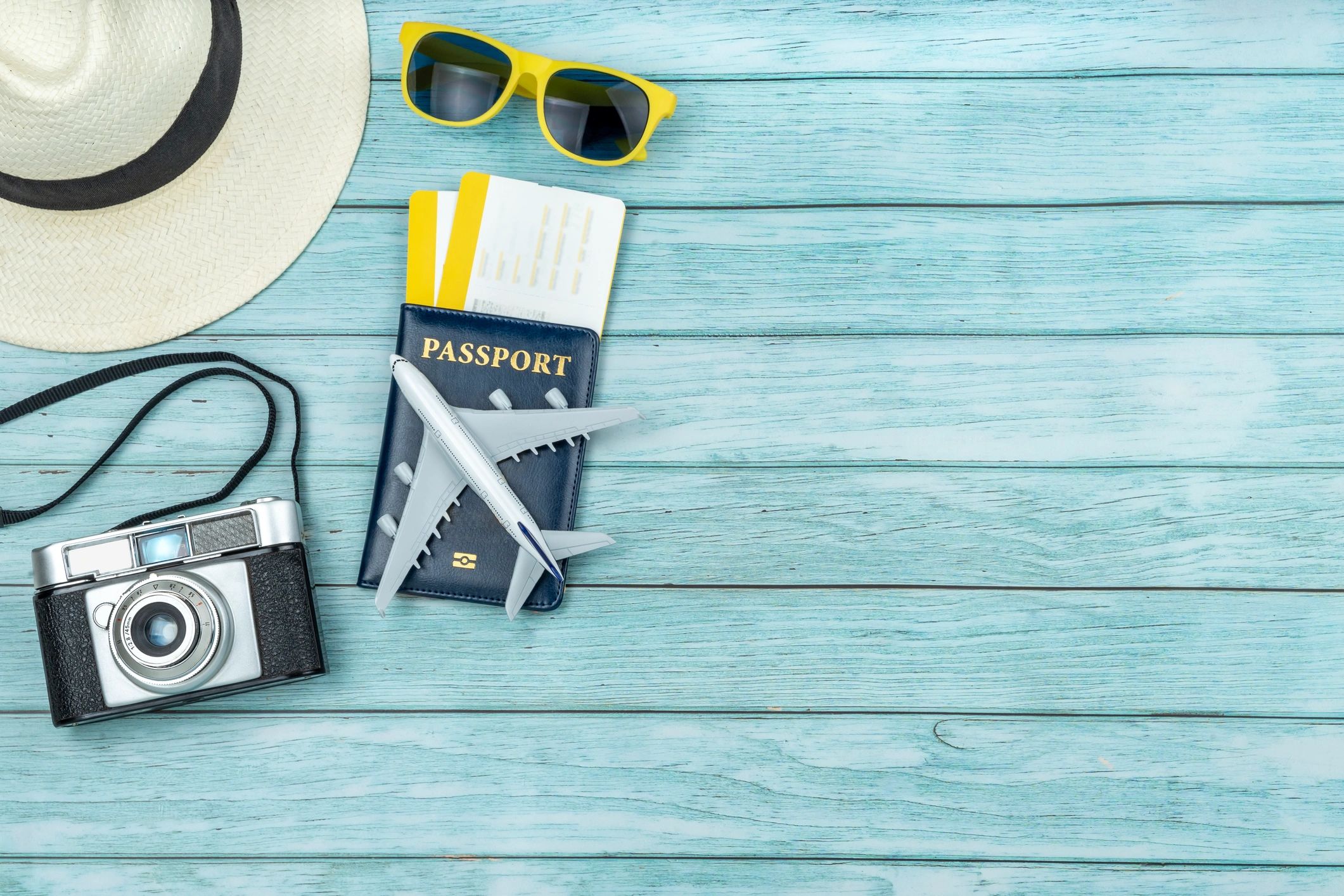 Flat lay of travel planning items including passport and boarding passes
